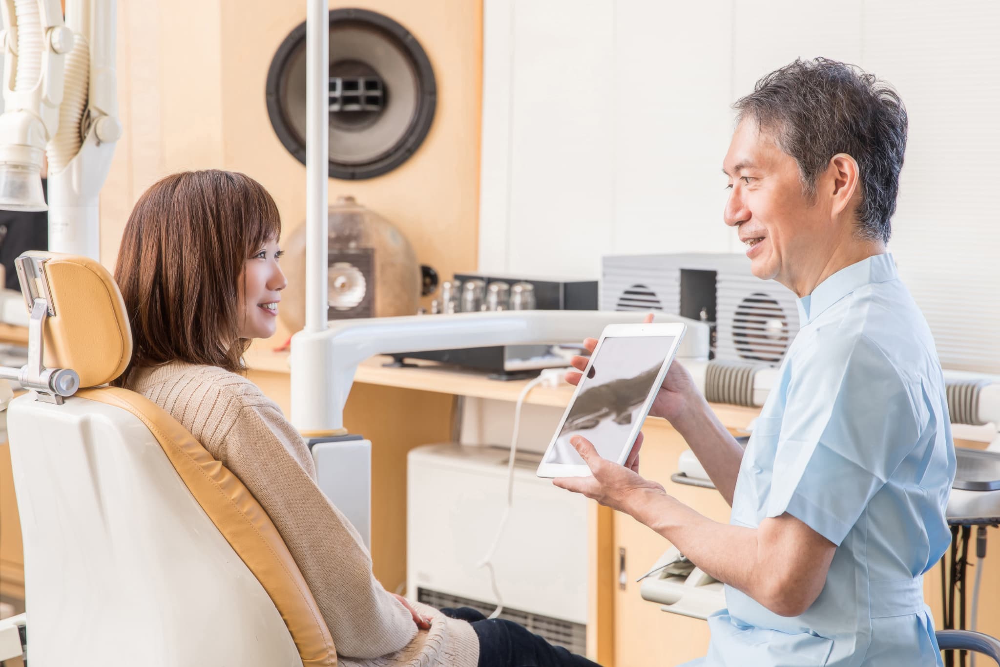 矯正中に虫歯ができた場合の対処法について患者に説明する歯科医師