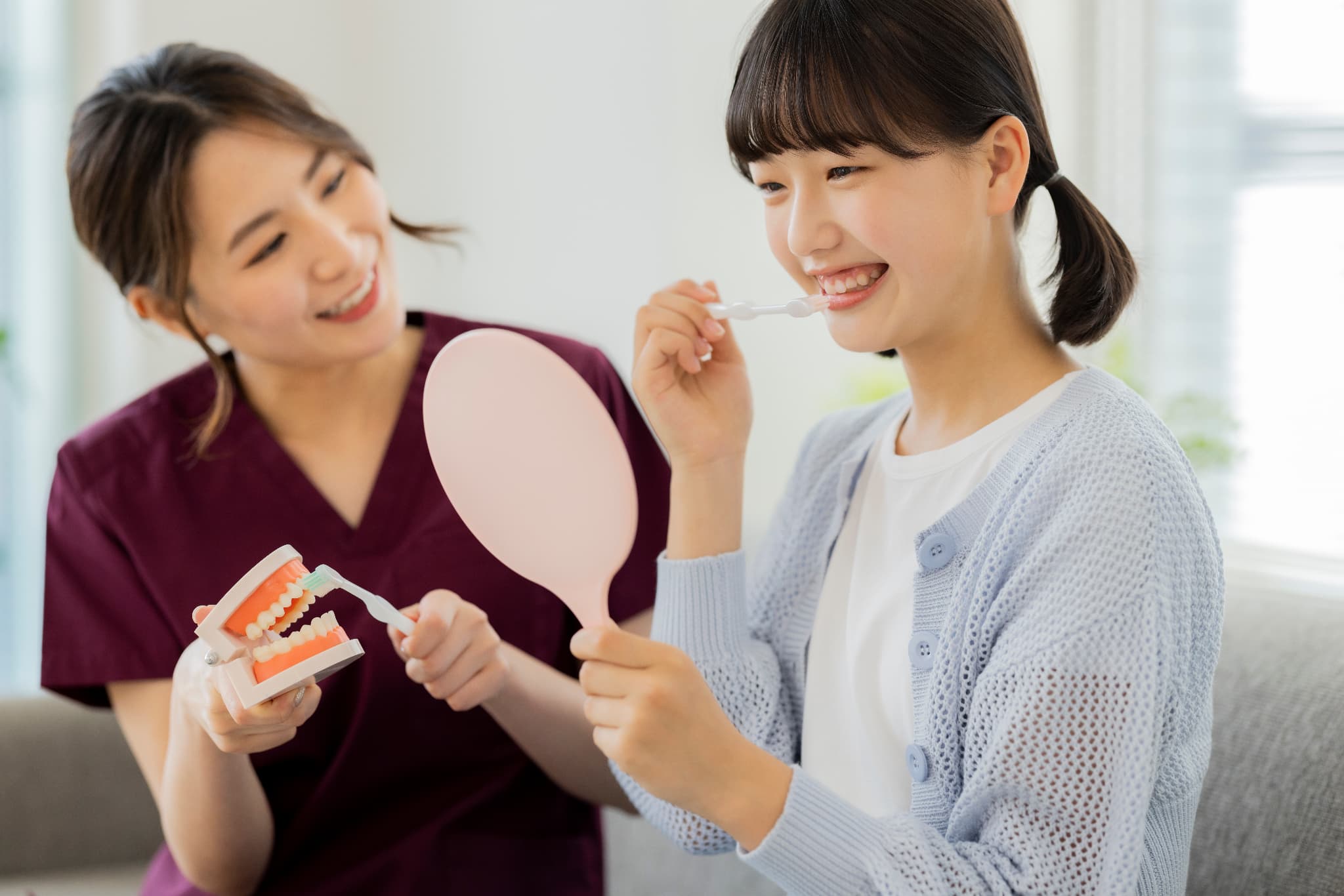 実際に磨いてもらいながらブラッシング指導する歯科衛生士